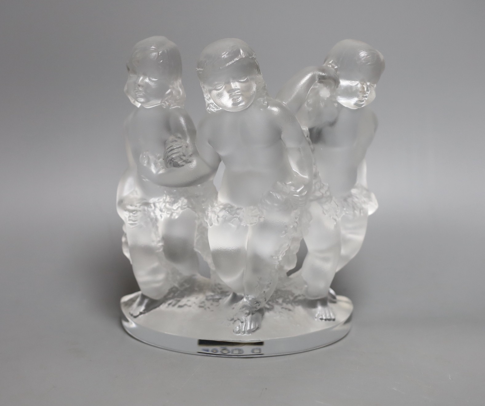 A Lalique glass model of three putti, boxed, 18 cms wide